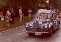 Car leading library group marching in parade